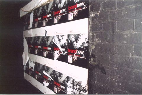 2000 Jeep Liberty - Multiple posters for the band 'brand new' are affixed to a wall, some torn and peeling.