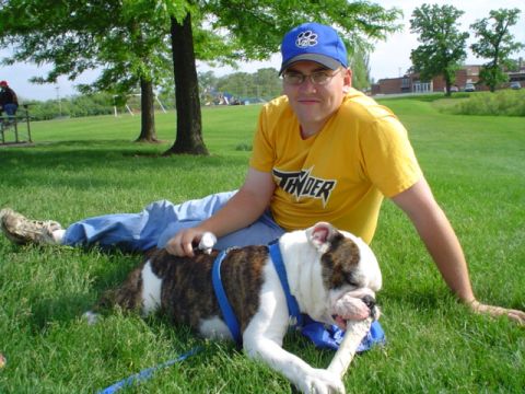 1993 Ford Bronco - A man relaxes on the grass with his bulldog, enjoying a sunny day outdoors.