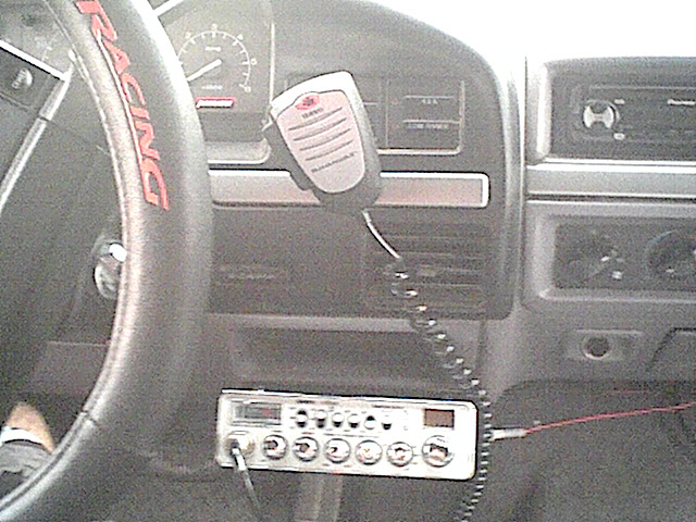 1994 Ford Bronco interior showing dashboard, steering wheel with 'RACING' text, CB radio, and microphone