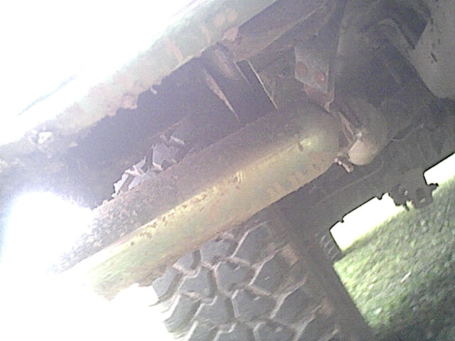 Undercarriage view showing exhaust pipe and tire tread