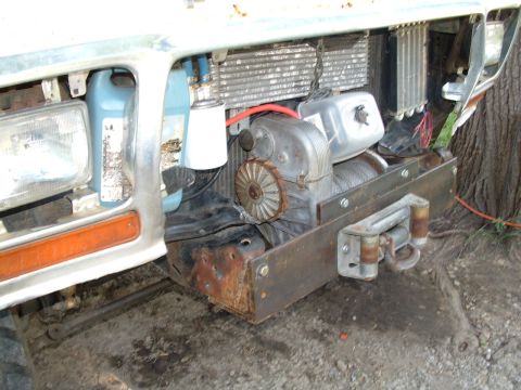 1979 Ford Bronco - Custom front bumper with a winch installed, tow hooks and visible cooling lines.