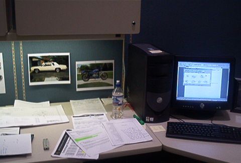 1985 Ford LTD Crown Victoria - Desk setup includes a computer, documents, and framed pictures of a car and a motorcycle.