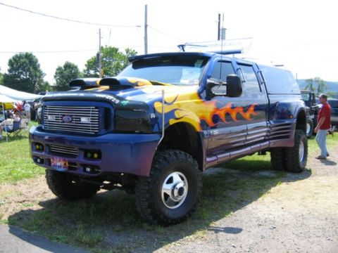 1994 Ford Bronco - This heavily modified Ford F-350 dually features custom flame paint and dual hood scoops.