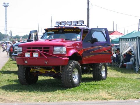 1994 Ford Bronco - This heavily modified truck features custom paint, off-road lights, and a lifted suspension.