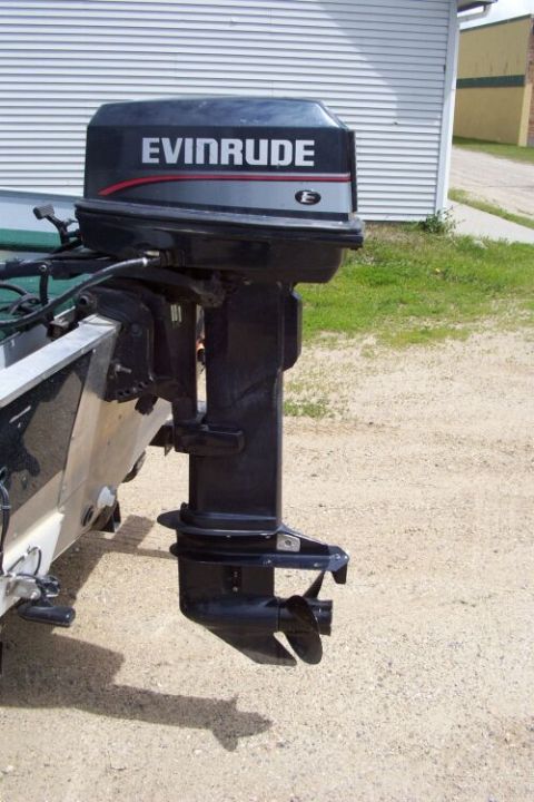 1996 Ford Bronco - An Evinrude outboard motor is mounted on the back of a boat, with the propeller visible below the water line.