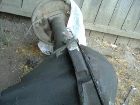 1989 Ford Bronco - Close-up of a vehicle's rear axle assembly, showing the brake drum and brake line.