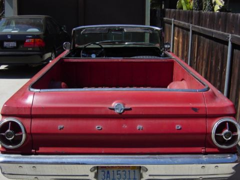 1965 Ford Ranchero - Rear view of a red 1965 Ford Ranchero convertible pickup truck, showing the Ford badging and taillights.