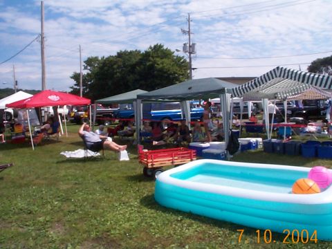 1978 Ford Bronco - An outdoor event with tents, people, and an inflatable pool in the foreground.