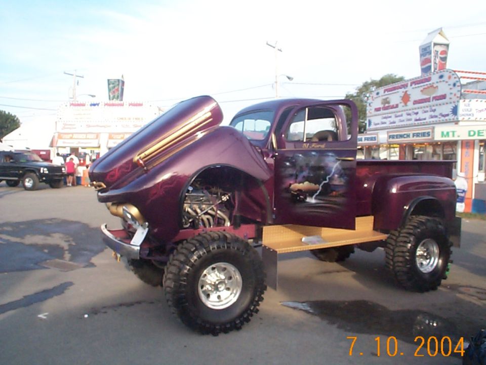 Purple custom pickup truck with open hood and lightning mural on door