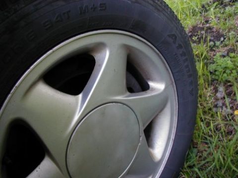 1997 Ford Taurus - A close-up of a 1997 Ford Taurus wheel and tire, with a watermark in the corner.