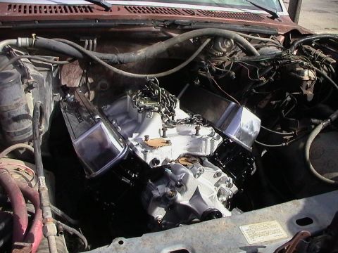 1985 Ford Bronco - The engine bay shows a recently installed engine with chrome valve covers and a new intake manifold.