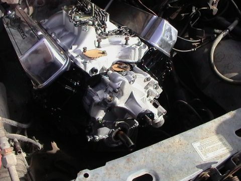 1985 Ford Bronco - Engine installation detail, showing chrome valve covers and a chain.