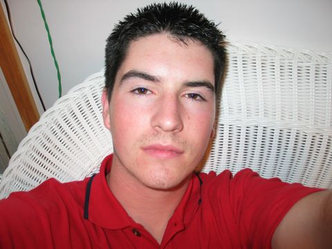 1995 Ford Bronco - A man is captured in a close-up selfie, seated in a white wicker chair.