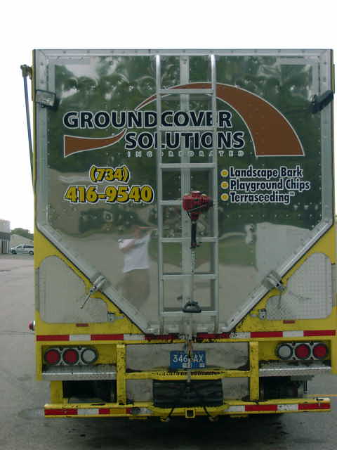 1998 Ford Ranger - The rear of a trailer displays company information and services offered, including landscaping and terraseeding.