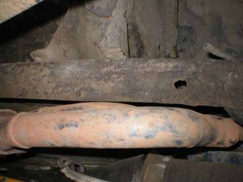 1978 Ford Bronco - Close-up of the undercarriage shows a rusty exhaust pipe and frame. Text from Supermotors.net is visible.
