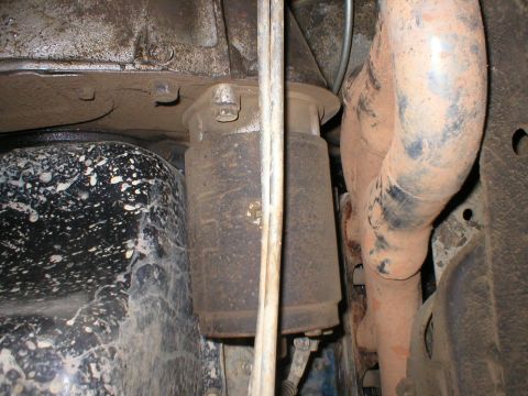 1978 Ford Bronco - Undercarriage view showing exhaust pipe and suspension parts. No specific vehicle identified.