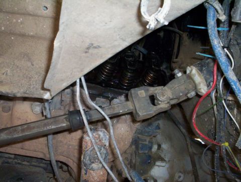 1978 Ford Bronco - This image shows a close-up view of the steering column mechanism and engine valve springs within a vehicle.