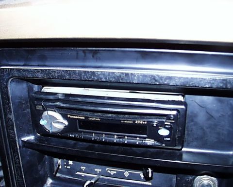 1988 Ford E250 - Close-up of a car's interior dashboard, showing a stereo and HVAC controls.