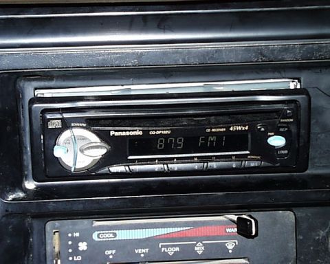 1988 Ford E250 - Close-up of a Panasonic CD receiver stereo installed in a vehicle's dashboard.