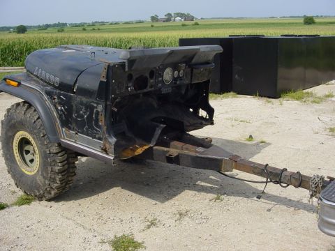 1992 Ford Bronco - A heavily modified Jeep CJ-7 Laredo body is mounted on a trailer, ready for transport.