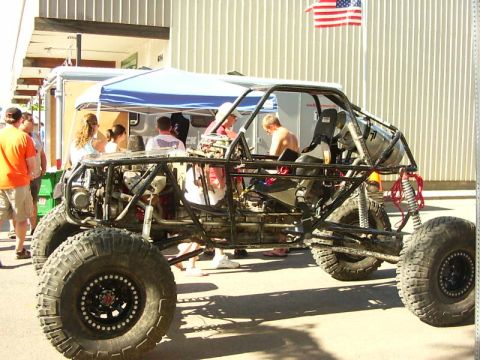 1990 Ford Bronco - This custom off-road buggy features a prominent roll cage and oversized tires, suggesting it's built for extreme terrain.