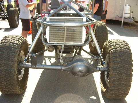 1990 Ford Bronco - This custom-built buggy features oversized tires and a prominent roll cage, suggesting it's designed for extreme off-road use.