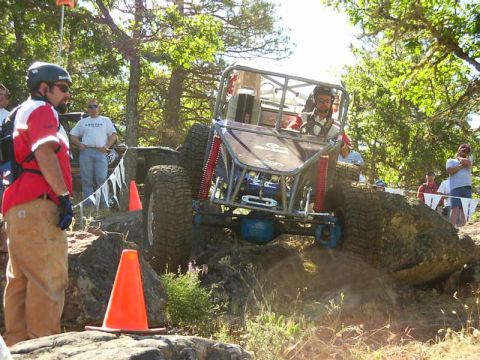 1990 Ford Bronco - A custom-built off-road buggy navigates a challenging rocky course during a competition.