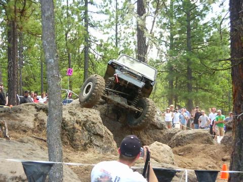 1990 Ford Bronco - An off-road vehicle navigates a challenging rocky terrain during an event.