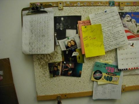 1997 Ford Taurus - A bulletin board displays personal photos, handwritten notes, a calendar, and various coupons, including one for Rue21.