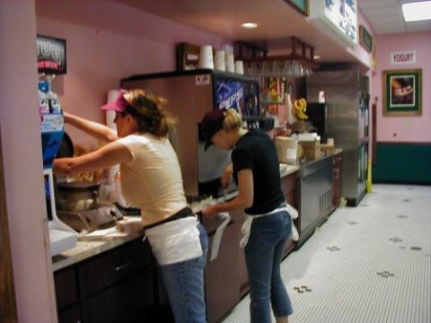 1997 Ford Taurus - Employees work behind a counter in what appears to be a food service establishment.