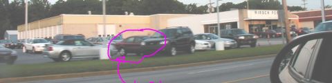 1997 Ford Taurus - A dark red 1997 Ford Taurus sedan is seen parked on a lot with other vehicles.