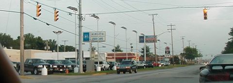 1997 Ford Taurus - A view of a used car lot with several vehicles visible, including trucks and SUVs.