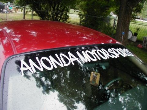 1997 Ford Taurus - Windshield banner on a red car reads 'ANONDA MOTORSPORTS'.