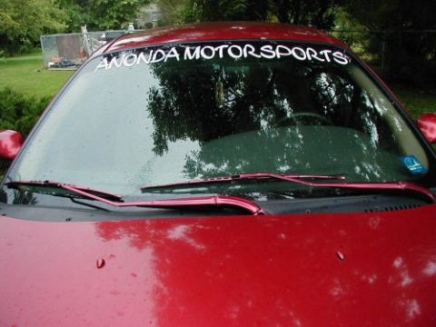 1997 Ford Taurus - A red car's windshield is visible, a banner that reads "ANONDA MOTORSPORTS" and a watermark for "SUPERMOTORS.net" at the bottom.