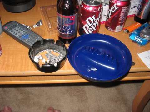 1988 Ford Bronco - A table displays beverages and a used ashtray, with a remote control nearby.