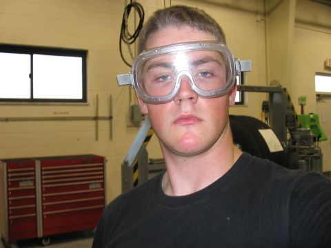 1988 Ford Bronco - A young man in safety goggles stands in what appears to be a workshop or garage environment.