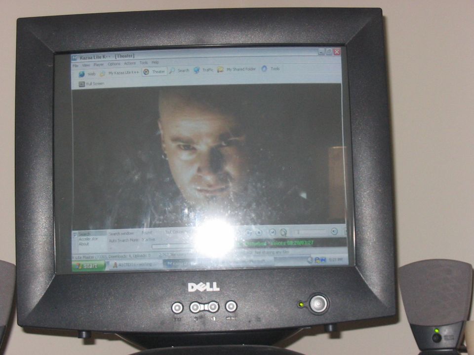 Computer monitor showing a close-up of a man's face from a movie