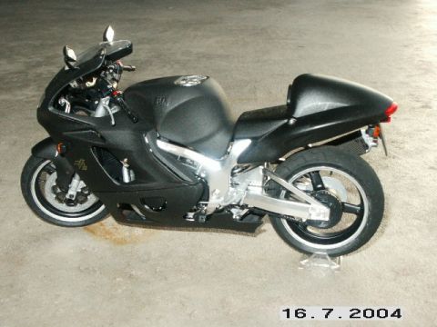 1998 Mercury Sable - A black sport motorcycle is displayed on a stand, showing its side profile.