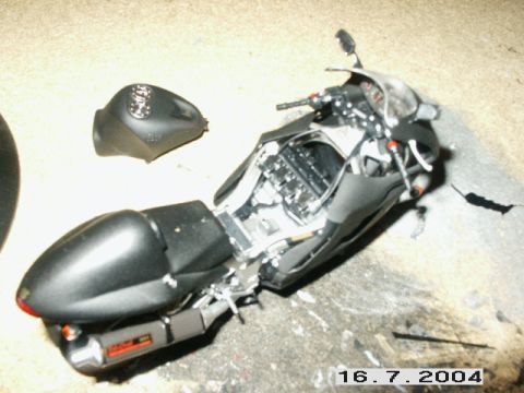 1998 Mercury Sable - A black motorcycle is shown with its fuel tank removed, revealing the engine components.