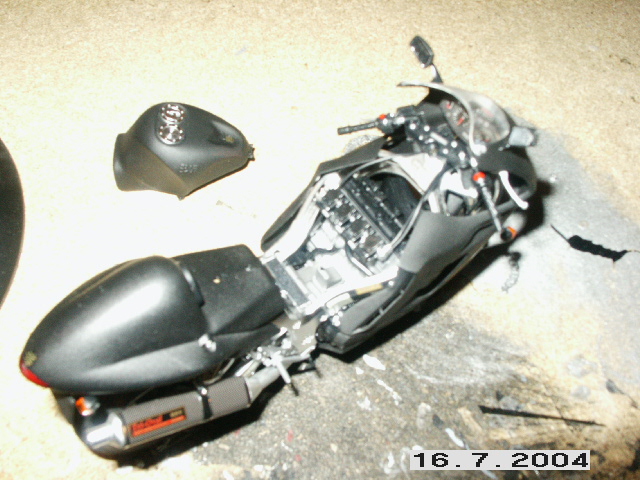 Black motorcycle with detached fuel tank and exposed engine