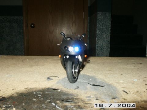 1998 Mercury Sable - A black sport motorcycle is shown from the front with its headlights illuminated.