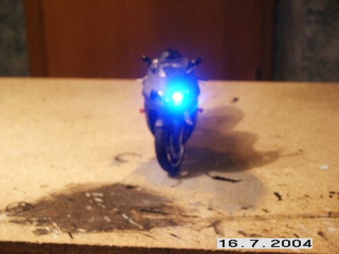1998 Mercury Sable - A toy motorcycle with illuminated blue headlights is viewed from the front.
