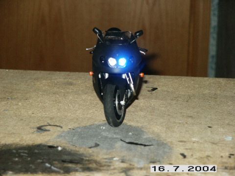 1998 Mercury Sable - A black motorcycle is shown from the front with its headlights illuminated.