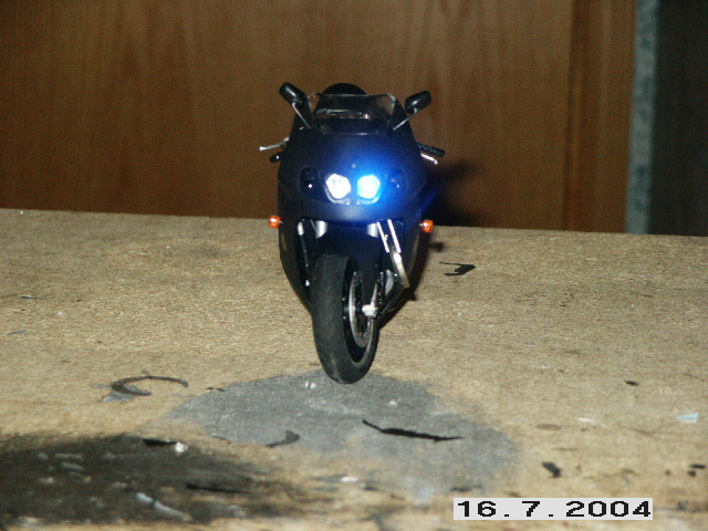 Black motorcycle front view with headlights on