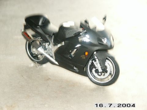 1998 Mercury Sable - A black sport motorcycle is shown from a three-quarter front view on a concrete surface.