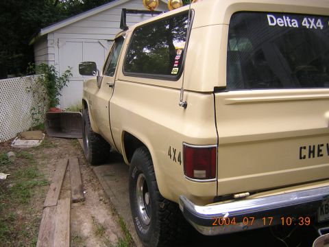 1984 Chevrolet Blazer - Rear view of a tan Chevrolet K5 Blazer with '4X4' decals and a 'Delta 4X4' sticker on the window.