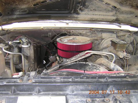 1984 Chevrolet Blazer - The engine bay of a 1984 Chevrolet Blazer is shown, revealing its internal components and aftermarket air filter.