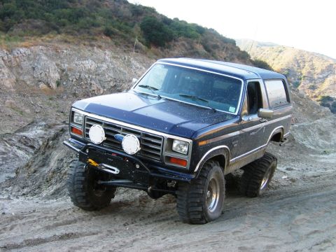 1985 Ford Bronco - This modified Ford Bronco navigates a , off-road terrain with steep inclines.