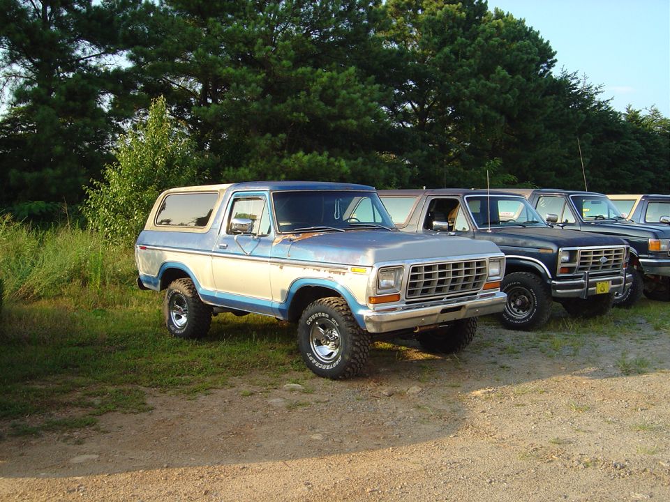 Two-tone blue and beige 1978 Ford Bronco parked on gravel, front-left view