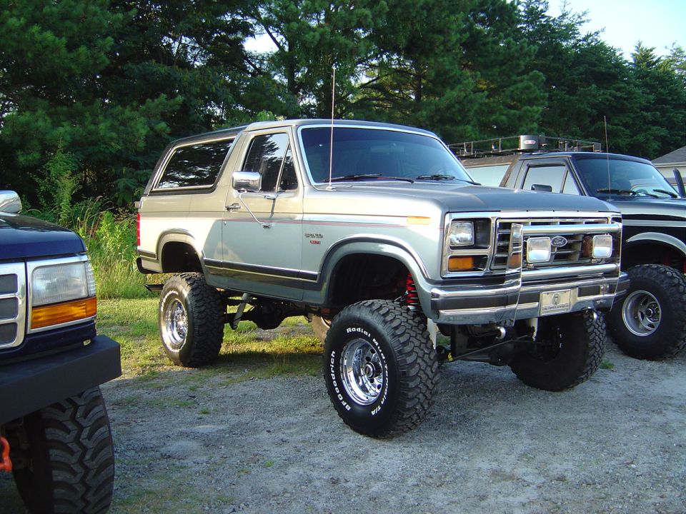 Silver and tan lifted Ford Bronco with chrome wheels and BFGoodrich tires